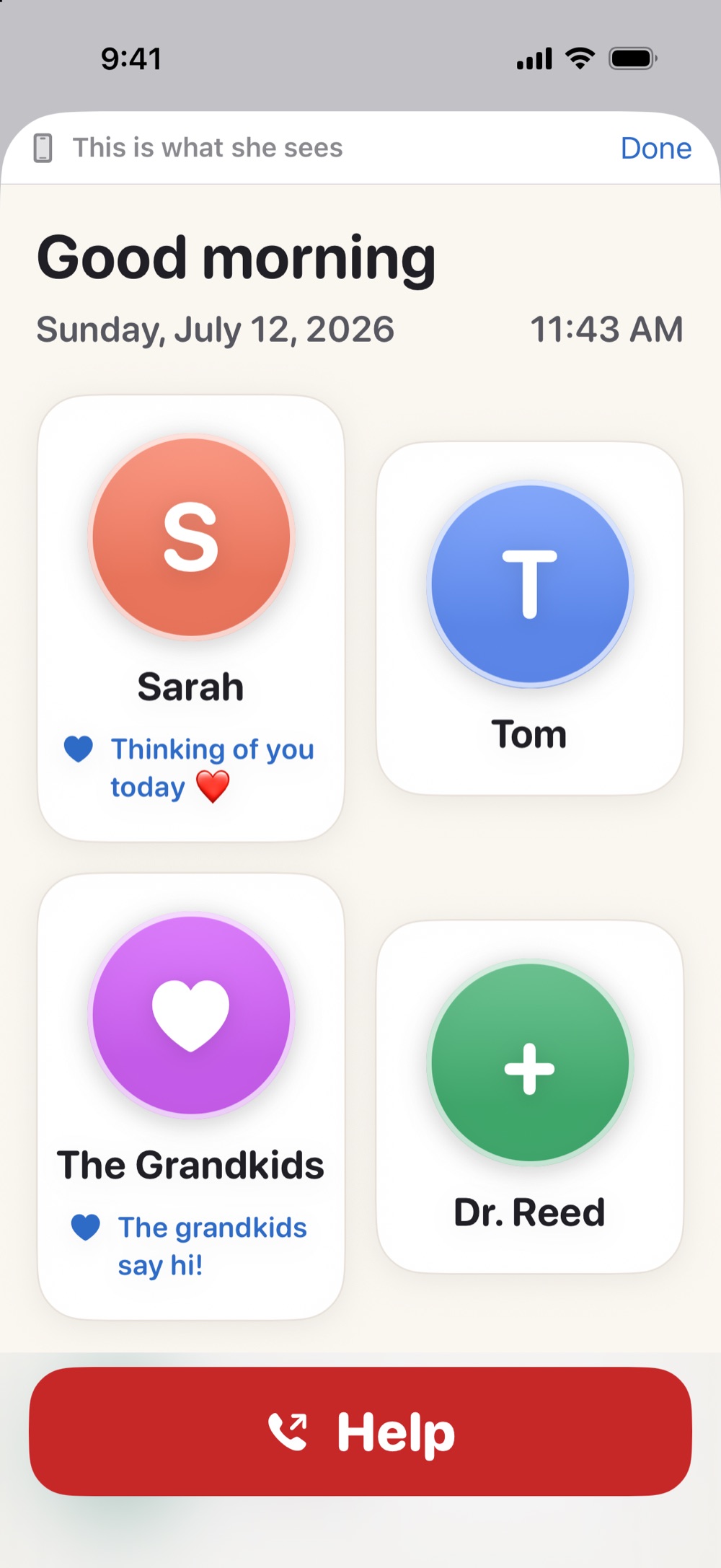 The companion app's live preview, a banner reading 'This is what she sees' above an exact rendering of the older adult's home screen with the family faces